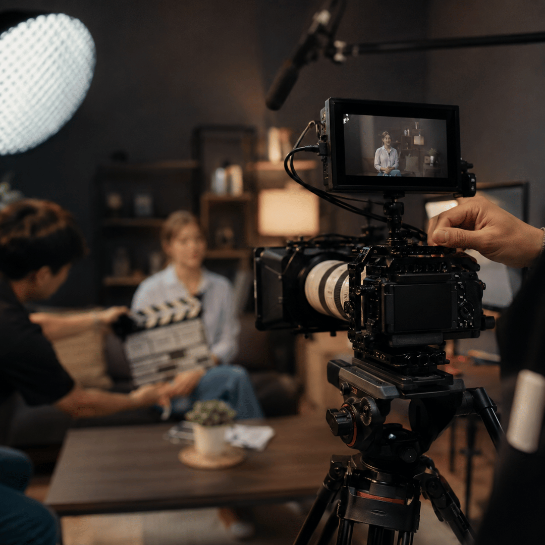 Professional video production setup with a camera filming an interview for a storytelling video.