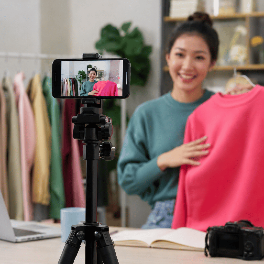 TikTok content creator recording a product video with a smartphone to promote a brand and reach more customers through TikTok marketing