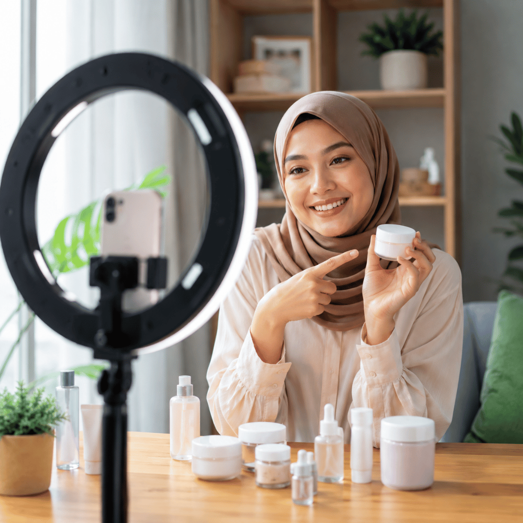 Young woman creating authentic user generated content for a skincare brand using a smartphone and ring light